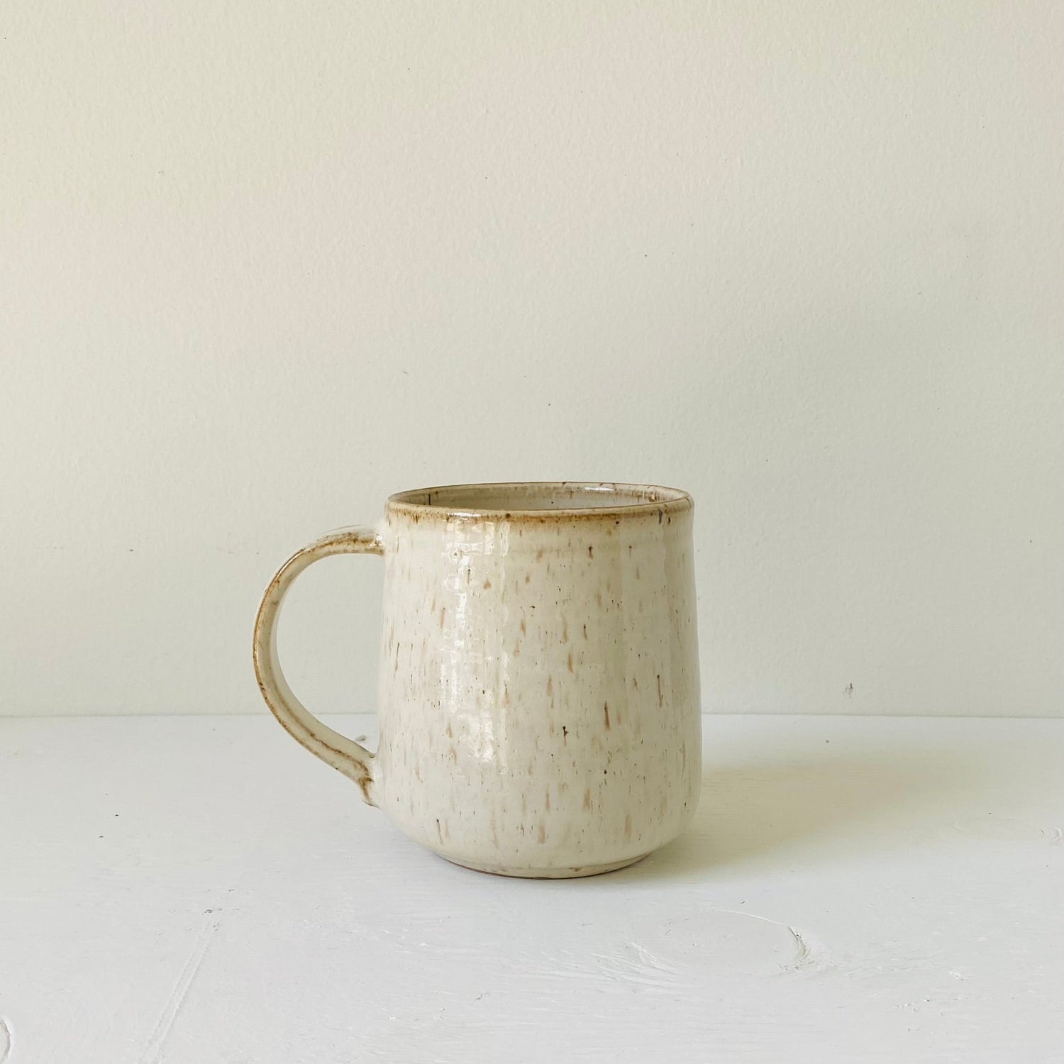&quot;Handmade ceramic mug with a large handle, balanced design, and minimalist style, perfect for coffee or tea.&quot;